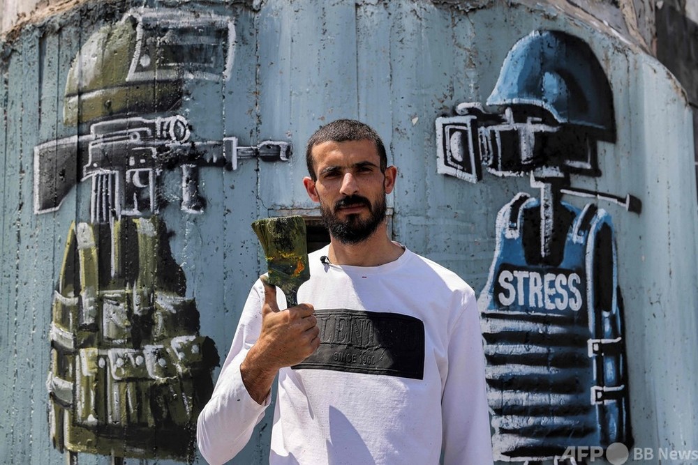 「グラフィティは抵抗の手段」 分離壁に絵描くパレスチナ人アーティスト
