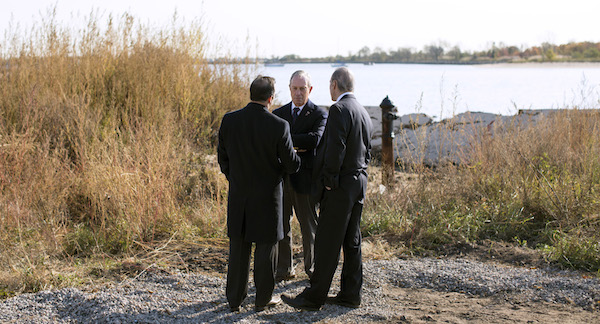 New York City Mayor Michael Bloomberg, center, talks with city council members Vincent Ignizio, left, and James Oddo while visiting a parks department project.