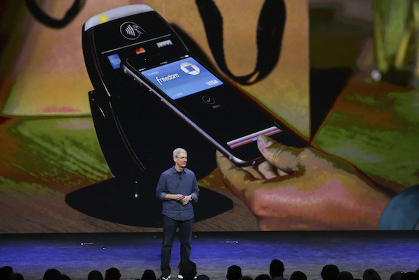 Tim Cook, Apple's chief executive, speaks about he Apple Pay system as it demonstrated on a screen during Apple’s new product announcement at the Flint Center.