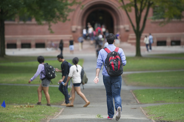 Students walk around the campus between classes at Harvard University in Cambridge, Mass.